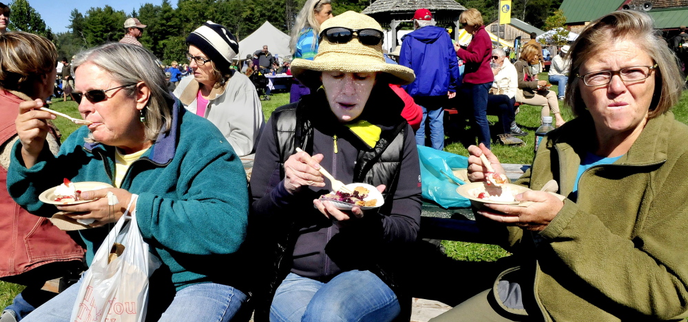 Fairgoers stop for dessert during the Maine Organic Farmers and Gardeners Association signature event, the Common Ground Country Fair, in Unity in 2014. MOFGA is among 15 organizations that have filed suit over USDA rule changes concerning the use of non-organic or synthetic substances used to produce food. Enjoying the wares, from left, are Barb Wood, Amy Howard and Myra Wilkinsen.