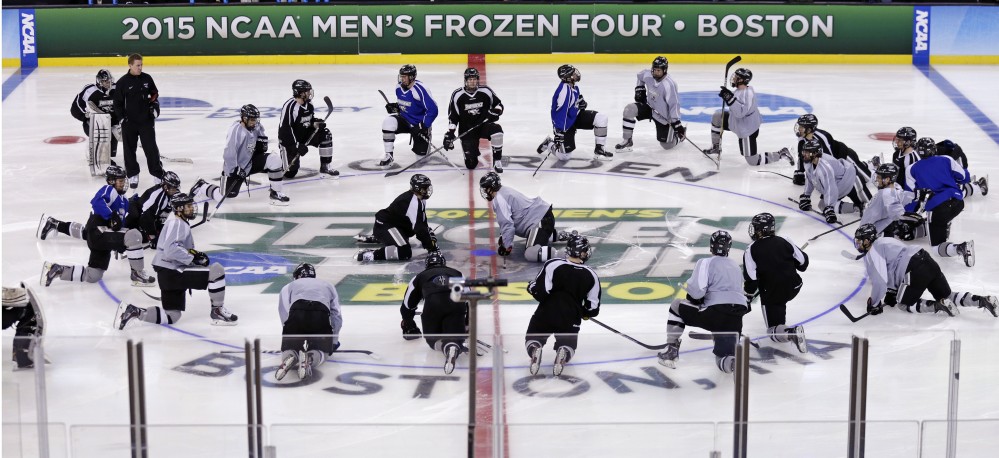 Providence players stretch out at center ice during practice for a Frozen Four men’s ice hockey championship semifinal in Boston on Wednesday. Providence will face Omaha in Thursday’s semifinal game.
