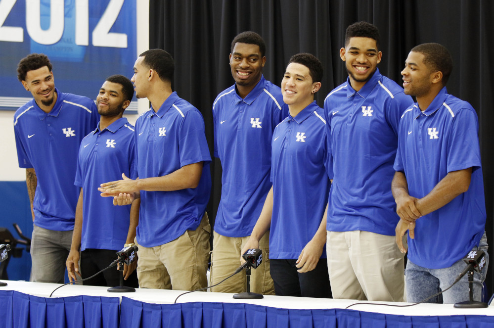 From left, Kentucky basketball players Willie Cauley-Stein, Andrew Harrison, Trey Lyles, Dakari Johnson, Devon Booker, Karl-Anthony Towns and Aaron Harrison stand during a news conference Thursday where they announced their intent to place their names in the NBA draft.