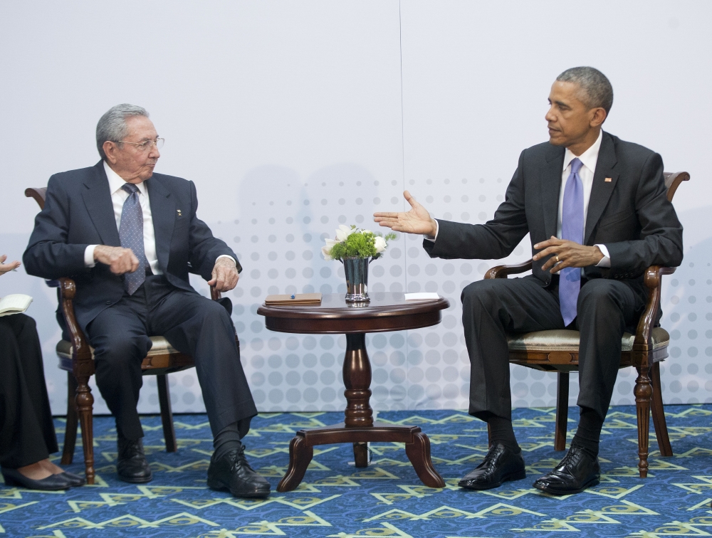 U.S. President Barack Obama, right, extends his hand towards Cuban President Raul Castro, left, to shake hands during their meeting at the Summit of the Americas, in Panama City, Panama, Saturday.