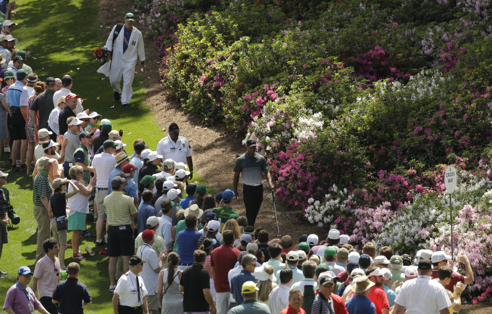 Tiger Woods walks down the sixth fairway during the third round of the Masters golf tournament Saturday in Augusta, Ga.
