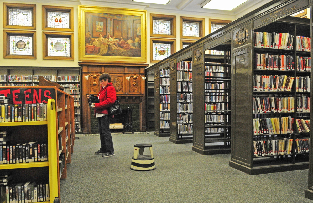 Karen Marriner looks for audiobooks on Saturday at Lithgow Library in Augusta. It was the last day before the library closes for renovation. It will temporarily be located in the Ballard Center on the city’s east side.