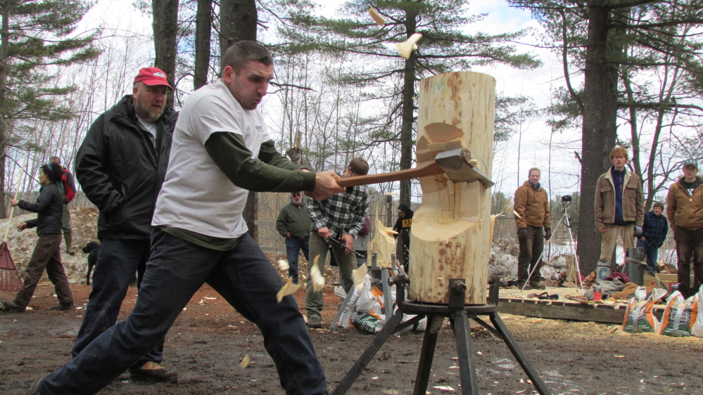 University of New Hampshire student Mitch Andrea hacks into a log during the vertical chop event at the annual “Mud Meet” woodsmen competition at Colby College in Waterville Saturday afternoon.