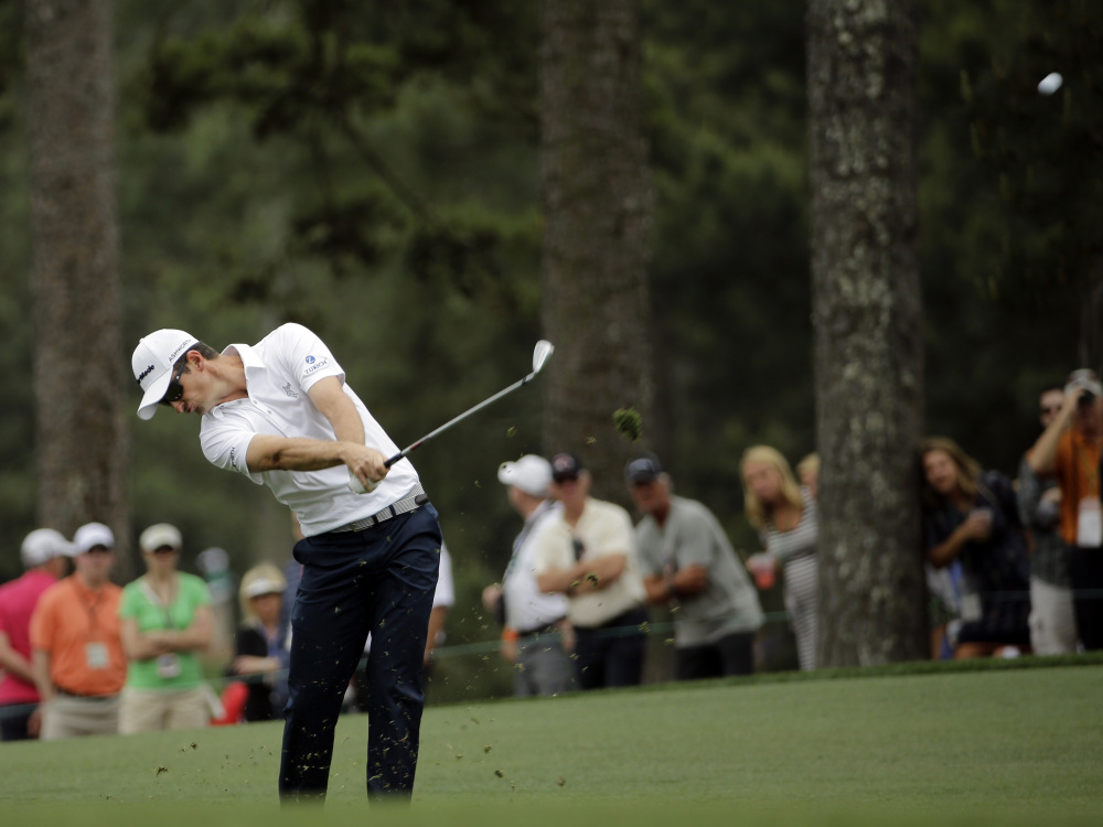 Justin Rose, of England, hits off the first fairway during the fourth round of the Masters golf tournament Sunday, in Augusta, Ga.