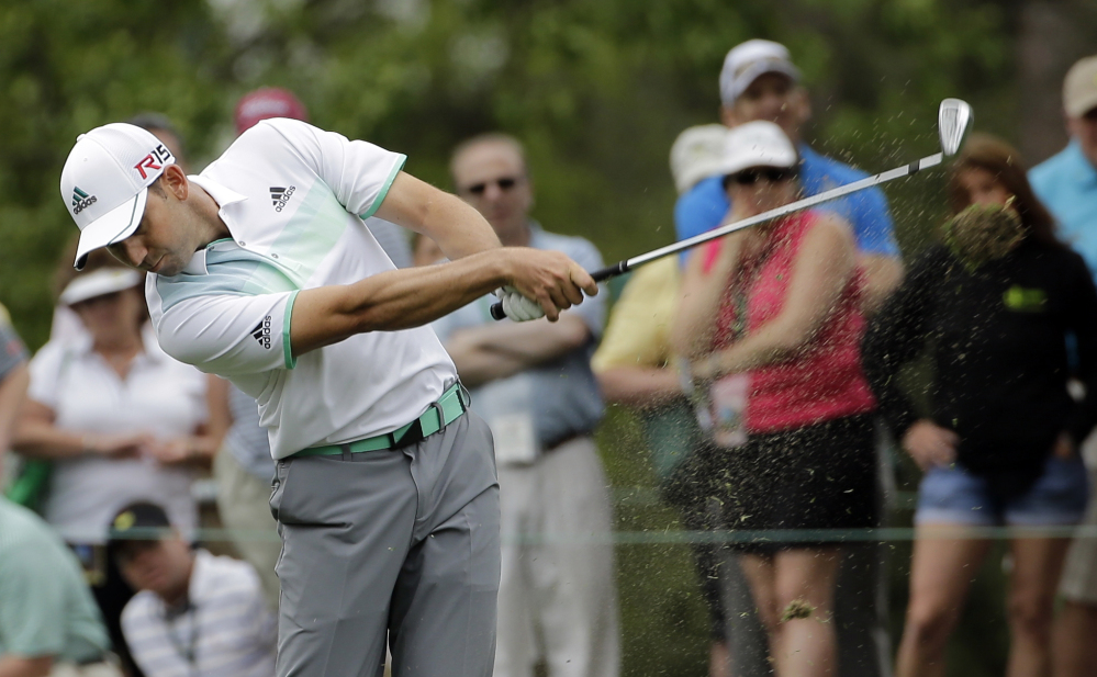 Sergio Garcia hits on the first fairway during the fourth round of the Masters golf tournament on Sunday in Augusta, Ga.