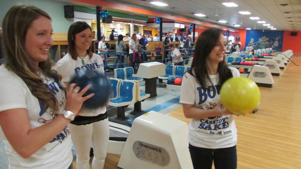 Mackenzie Pinette, Kacey Wilcox and Casey Carson get ready to roll bowling balls during the Bowl for Cassidy’s Sake fundraising event Saturday at Spare Time Recreation in Waterville. The event raised more than $36,000 for a Big Brothers Big Sisters program started at Messalonskee High School in Oakland in honor of Cassidy Charette, who was killed in a hayride accident last October.