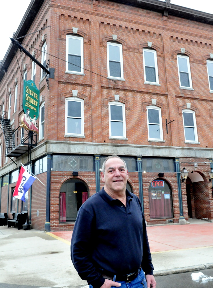 Charlie Giguere stands outside his Silver Street Tavern and renovated apartment building in Waterville. Gigure Management Group has received the Business of the Year award from the Mid-Maine Chamber of Commerce.