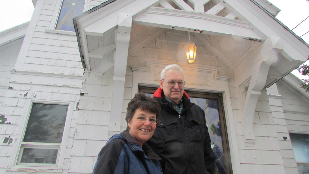 Rachel and James Kilbride stand in front of St. Bridget’s church on Main Street in North Vassalboro. The couple bought the disused church in January and plan to restore and reopen it as an event and community space.