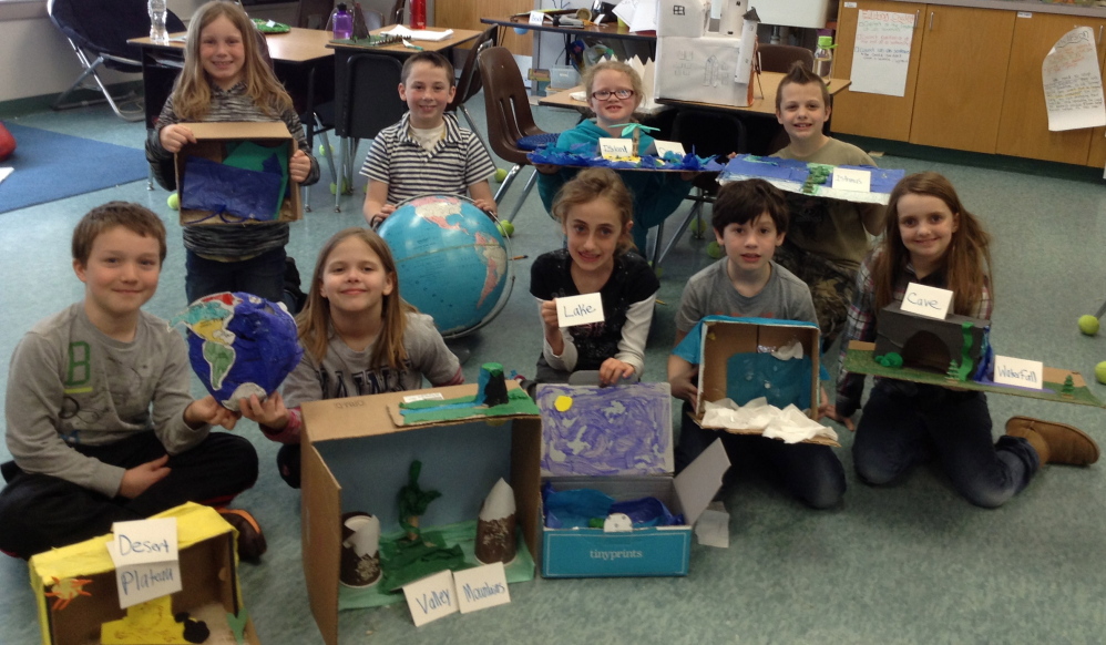 Wayne Elementary School third-grade students share the handcrafted models they made as part of their “Incredibly Interesting Geography Exhibit.” In front, from left, are Eli Reynolds, Lillian Pease, Ariana Tully, Elliot Desjardins and Jacie Dagneau. In back, from left, are Anna Albert, Wyatt Stevenson, Margaret Morrill and Isaac Mason.