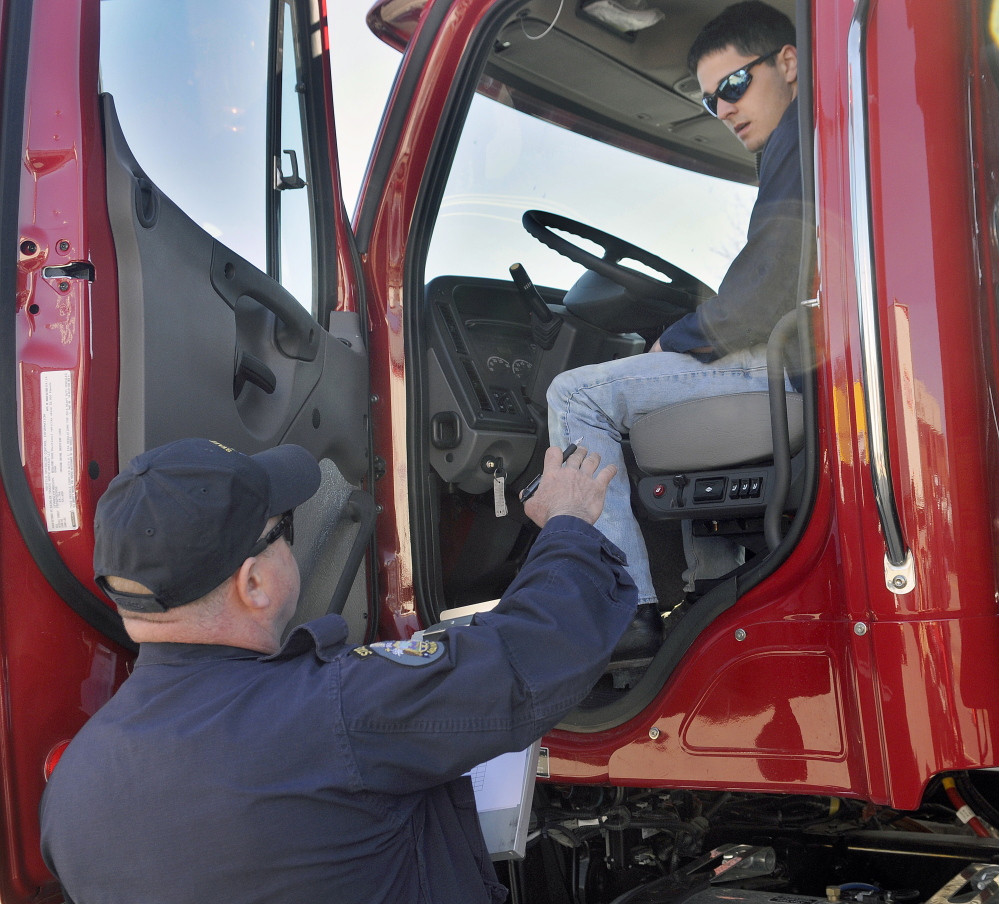 Parker Gardner, 17, of Lincoln, inspects a dump truck Wednesday with State Trooper Chris Foxworthy during the Dick Dolloff Memorial Student Driving Competition at the Augusta Civic Center. Students from across Maine competed in the event to test the skills of high school tractor-trailer operators. Troopers with the truck weight division tested teenagers on their knowledge of truck safety.