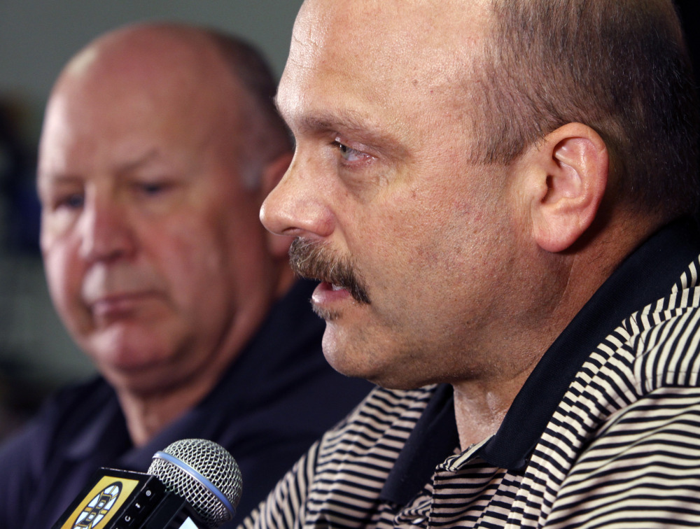 Boston Bruins general manager Peter Chiarelli, right, speaks alongside head coach Claude Julien at a news conference at TD Garden Monday. Chiarelli was fired Wednesda after the Bruins failed to reach the playoffs for the first time in eight years.