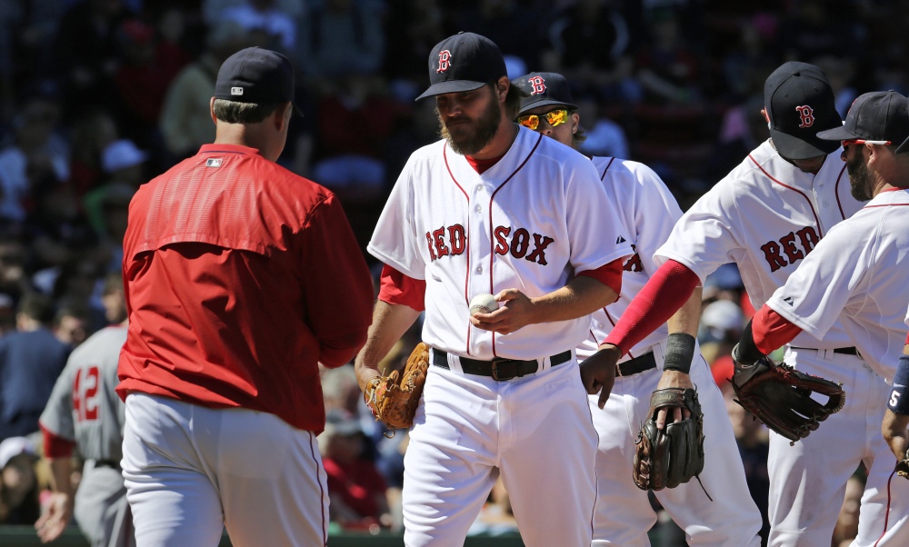 Boston Red Sox starting pitcher Wade Miley hands the ball to manager John Farrell as he is taken out of the game after giving up a three-run double to Washington Nationals catcher Wilson Ramos during the third inning Wednesday at Fenway Park. Miley gave up seven earned runs in his short outing.