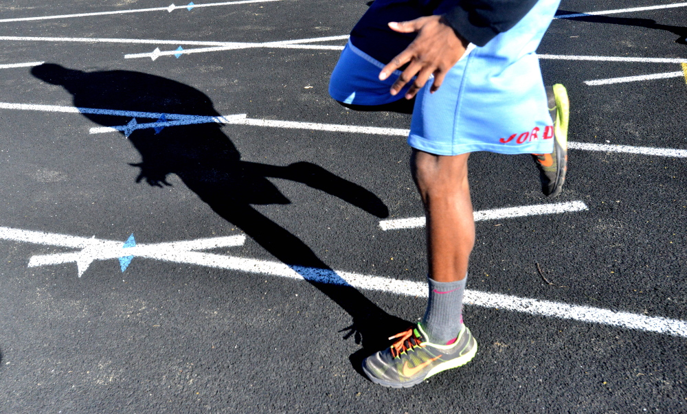Members of the Thomas College track club work out Wednesday at Winslow High School.