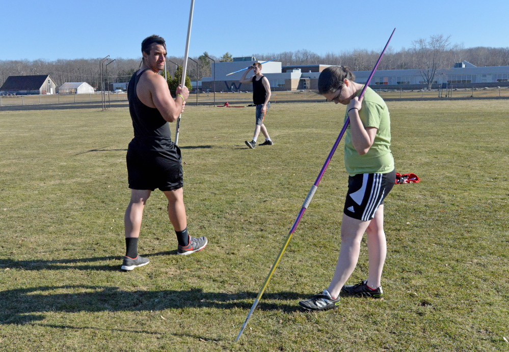 Nolan Callahan, left Michael Chambers, back center, and Katy Donovan, right, work out during the Thomas College track club practice Wednesday at Winslow High School.