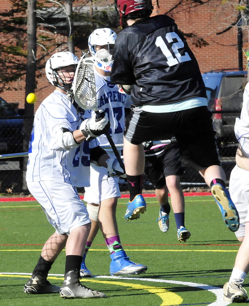 Staff photo by David Leaming 
 Maine Central Institute's Nick Bollinger (12) takes a shot against Lawrence during a boys lacrosse scrimmage Tuesday at Thomas College. Lawrence is fielding a varsity boys lacrosse team this spring.