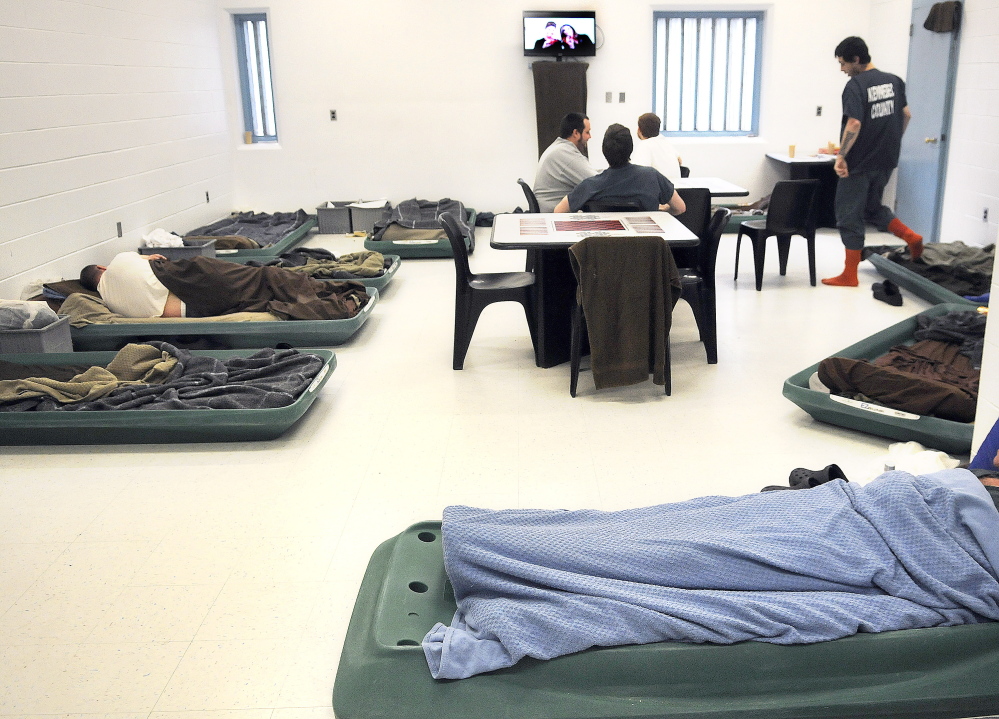Inmates watch television in April in an overcrowded pod at the Kennebec County Correctional Facility in Augusta. Men incarcerated at the facility often sleep on the floor because of a lack of space.