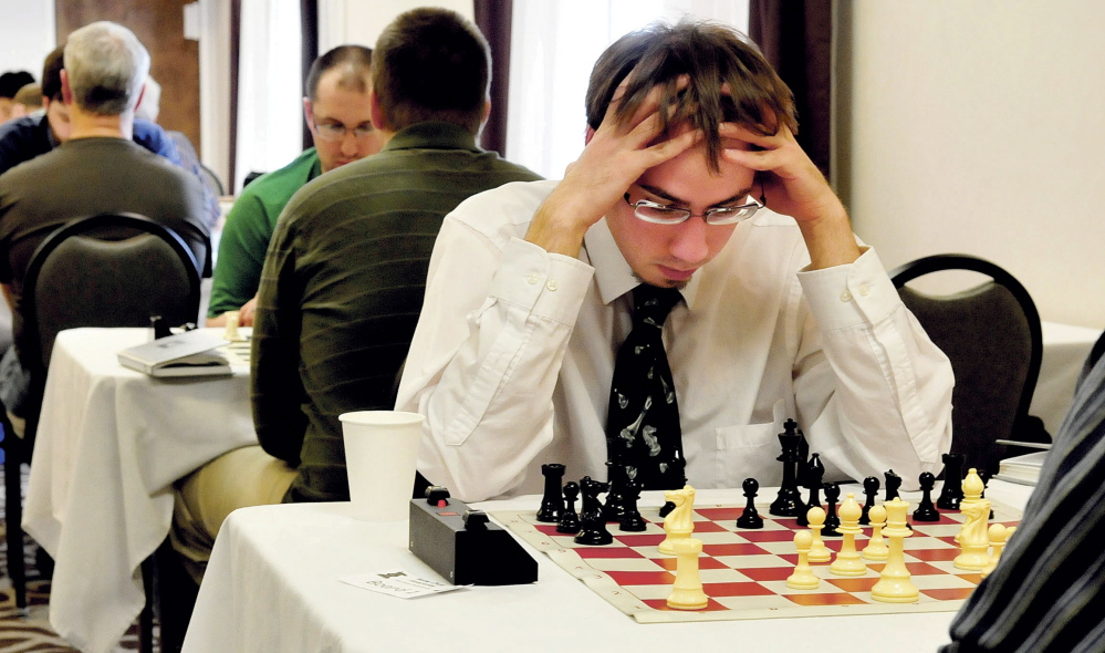 Chess player Aaron Spencer thinks about his next move against winner Jarod Bryan during Maine Closed Chess Championship in Waterville on Sunday.