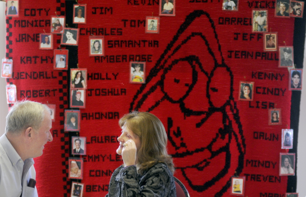 Ralph and Linda Bagley, of Harmony, speak Sunday in front of a tapestry of Maine homicide victims during the annual meeting of the Maine Chapter of Parents of Murdered Children in Augusta. The Bagleys raise awareness about domestic violence after losing their daughter and grandchildren. In June 2011, Amy Bagley Lake, 38, long with her children, Coty, 13, and Monica, 12, were murdered in Dexter by her estranged husband, Steven Lake, who later died when he shot himself.