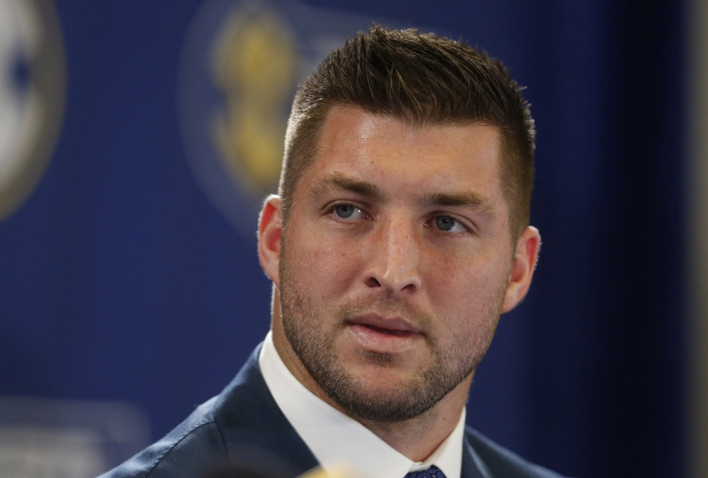 In this Dec. 5, 2014, file photo, Tim Tebow speaks during an SEC television broadcast in Atlanta.