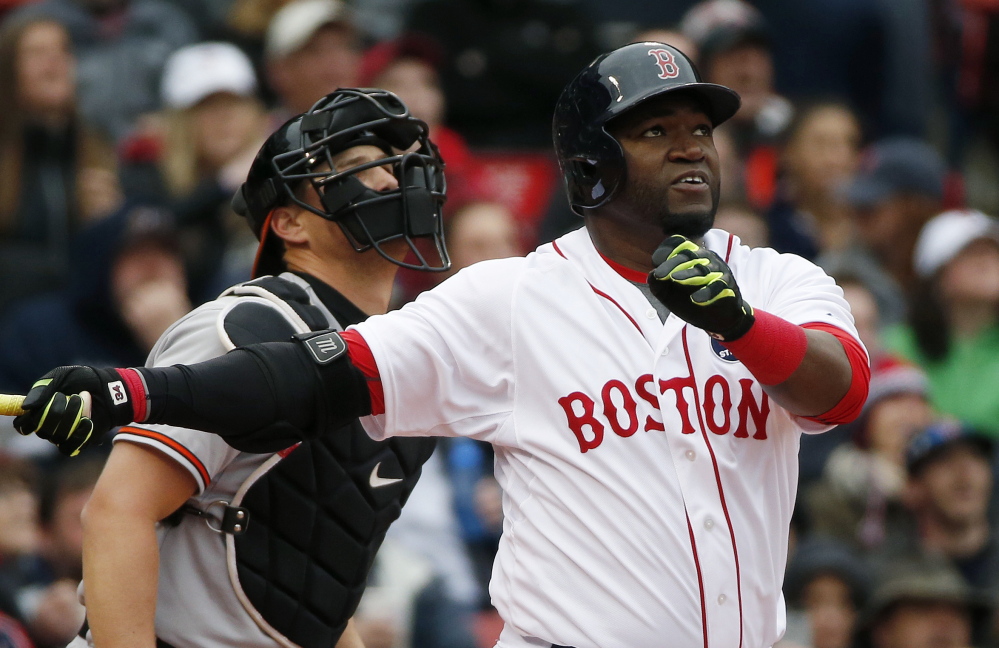 Boston’s David Ortiz, right, watches his sacrifice fly in front of Baltimore Orioles’ catcher Ryan Lavarnway during the first inning.