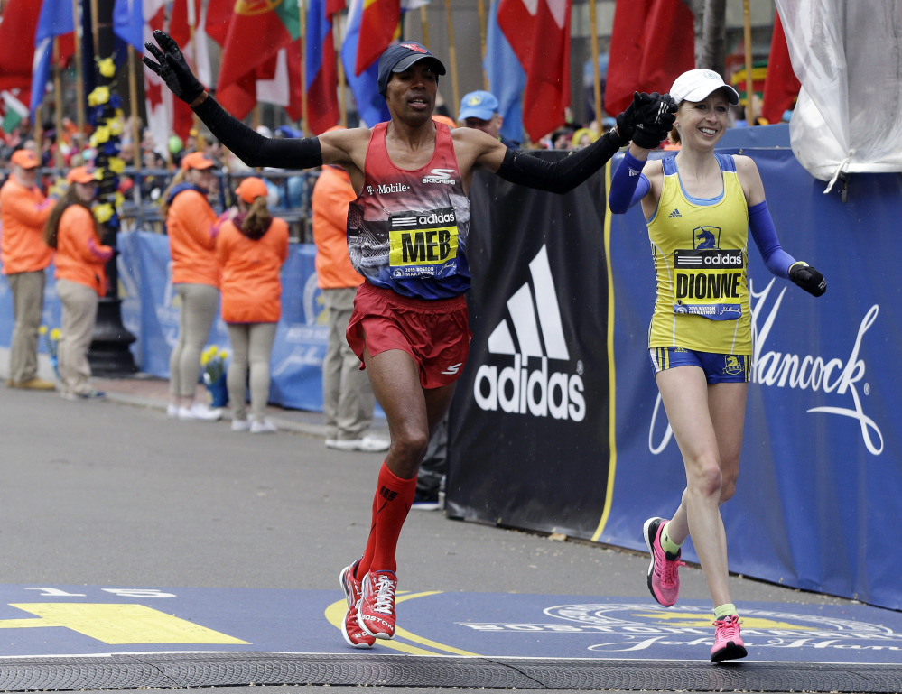 Meb Keflezighi, left, and Hilary Dionne finish the Boston Marathon on Monday. Should Boston host the Olympics in 2024, the historic course will not be able to host a marathon, as it does not meet IAAF certification.