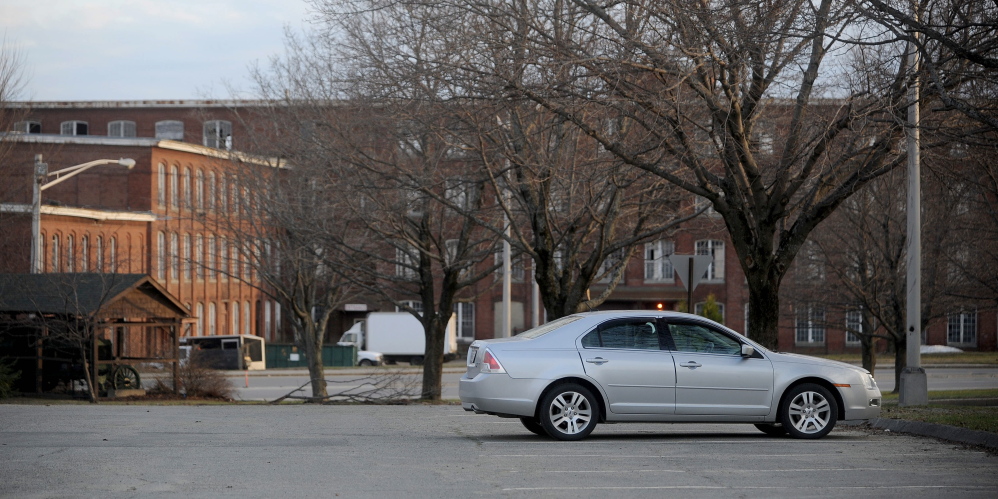 City parking lot on Front Street in Waterville is empty in the evening hours on Wednesday, and the Hathaway Creative Center is seen in the background, about a quarter-mile away. The city rejected an offer Tuesday from Hathaway developer Paul Boghossian to lease the lot to meet bank requirements for parking in order to finance the next phase of the mill rehabilitation.