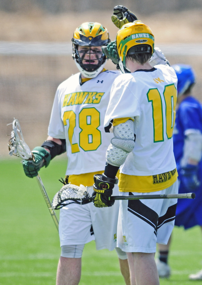 Marancook’s Josh Murphy, left, celebrates with teammate Denver Cram after Cram scored during a game Friday afternoon against Oak Hill at Kents Hill School. The Hawks soared to a 20-1 victory.