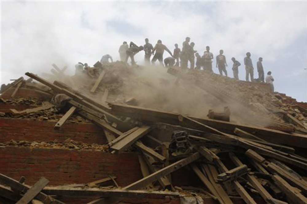 Volunteers help remove debris of a building that collapsed at Durbar Square, after an earthquake in Kathmandu, Nepal, on Saturday.
