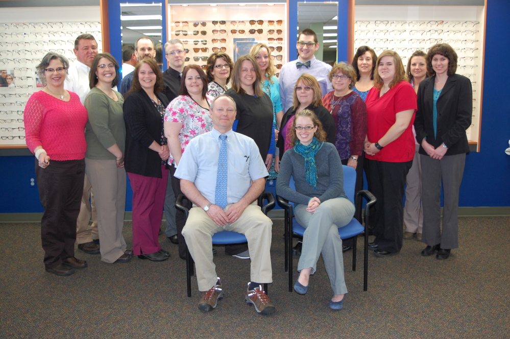 Dr. Richard Smart, front with Dr. Lesley Sobeck, poses with the staff of the Augusta Smart Eye Care Center. Smart and his company are celebrating 25 years with an open house at the Western Avenue center Friday.