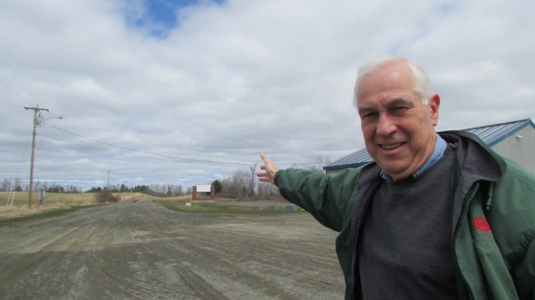 Doug Cutchin points to land open for development along Industrial Drive in Fairfield. Cutchin is moving forward with a plan to donate land to the town to extend the road to the Waterville city line and hopes to connect it to Industrial Street in Waterville.
