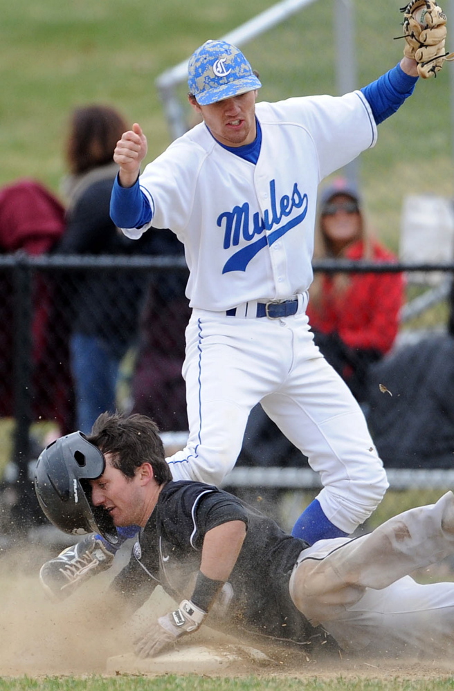 Bowdoin College’s Chris Nadeau, 8, dives to first base on the bunt attempt as Colby College’s Tyler Starks, 1, tags him out on the force play Saturday at Colby College in Waterville.