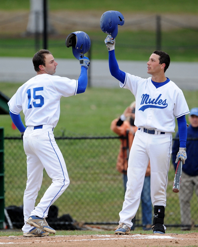 Colby College’s Tommy Forese, 14, celebrates with teammate Jason Buco, 15, after Buco homered off Bowdoin College in the first inning Saturday at Colby College in Waterville.