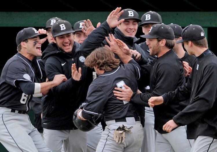 Bowdoin College celebrates with teammate Chris Cameron, 1, after scoring against Colby College on Saturday in Waterville.