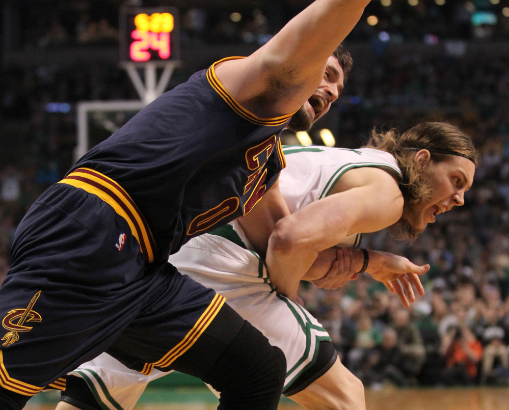 AP photo
Cleveland Cavaliers forward Kevin Love, left, is dragged by the arm by Boston Celtics center Kelly Olynyk during the first quarter of a first-round playoff game Sunday in Boston. The play resulted in an injury to Love that forced him from the game.
