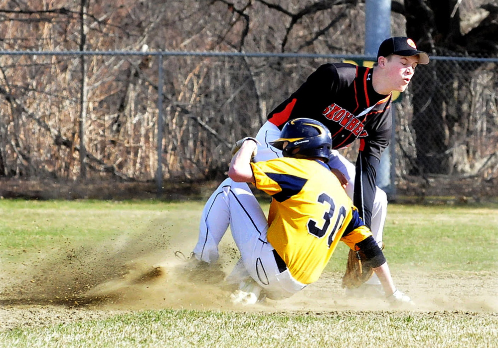 Skowhegan’s Garret McSweeney attempts to tag out Mt. Blue runner Ethan Andrews during a Kennebec Valley Athletic Conference Class A game Monday afternoon in Farmington. Mt. Blue won 11-1.