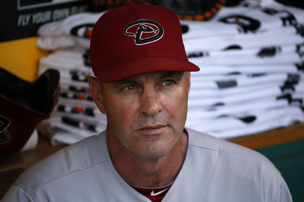 In this July 3, 2014, file photo, then-Arizona Diamondbacks manager Kirk Gibson sit in the dugout before a baseball game against the Pittsburgh Pirates in Pittsburgh.