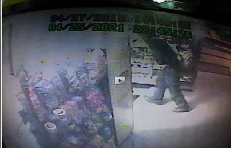 A burglar is seen in an image caught by a store security camera at Arkay’s Pizza in Farmington. Police are asking for the public’s help in identifying the person.