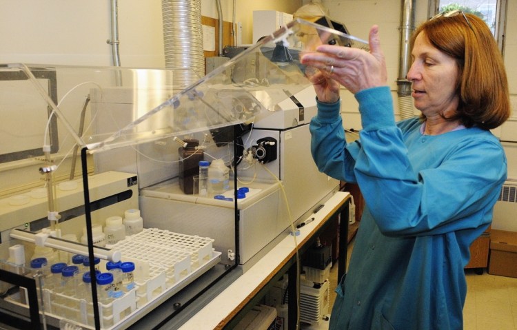 Chemist Cheryl Soucy runs water tests in the Maine Center for Disease Control and Prevention in Augusta in 2014. Soucy uses the inductively coupled plasma mass spectrometer to test water for arsenic and other contaminants.