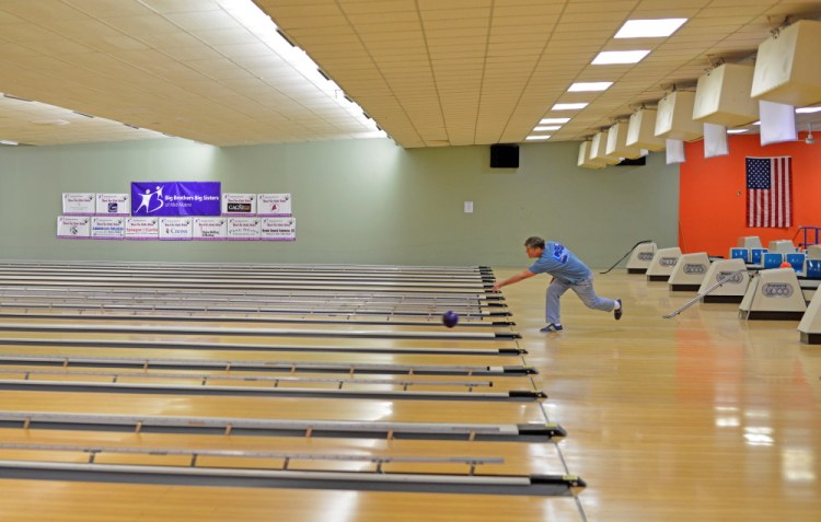 Rick Gilbert rolls one of the last frames at SpareTime Recreation on West River Road in Waterville on Tuesday. The final day of bowling — a charity tournament — is Wednesday. The bowling alley has been sold and is being converted for use by a nearby church.