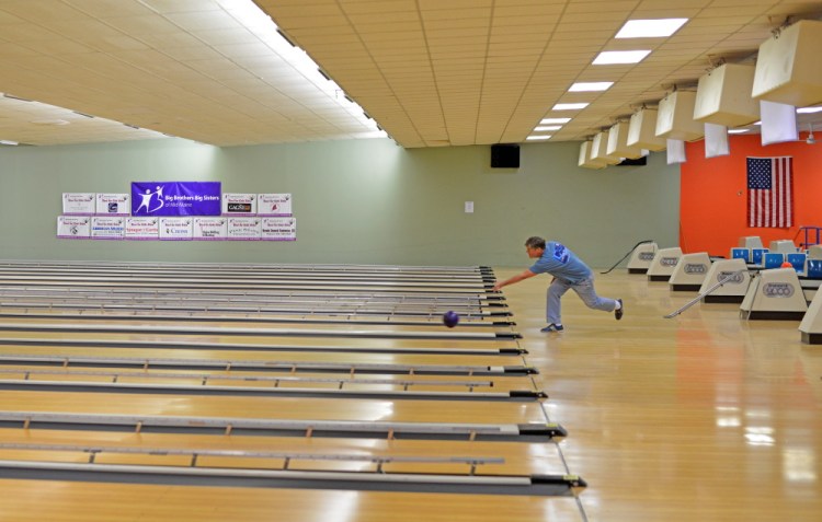Rick Gilbert rolls one of the last frames at SpareTime Recreation on West River Road in Waterville on Tuesday. The final day of bowling — a charity tournament — is Wednesday. The bowling alley has been sold and is being converted for use by a nearby church.
