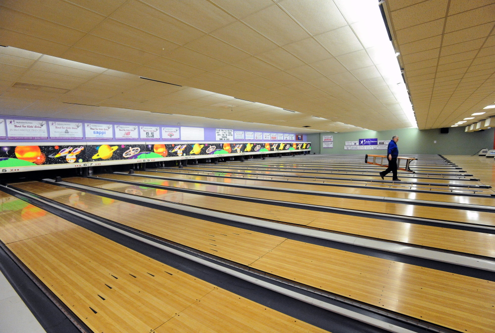 Bill Farnum, manager at Spare Time Recreation on West River Road in Waterville, cleans the lanes one last time on Tuesday in preparation for the alley’s final day with the Bowl for Kids’ Sake fundraiser on Wednesday.