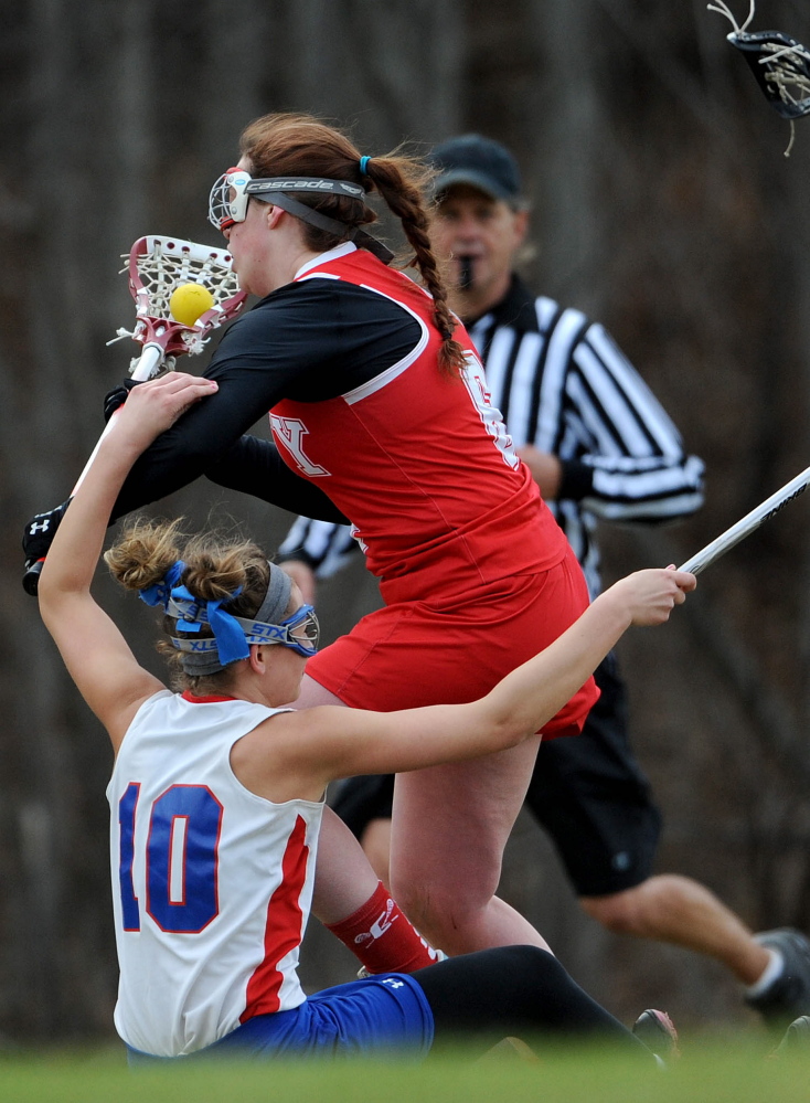 Cony’s Mary Kirschner (6) collides with Messalonskee’s Riley Field (10) on Tuesday in Oakland.