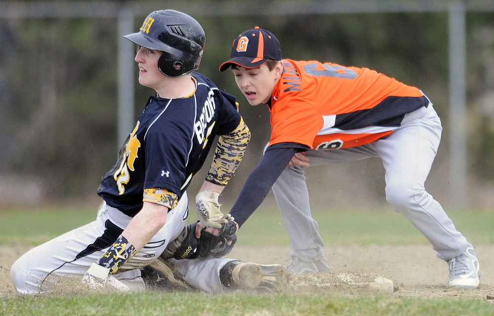 Gardiner’s Devon Maschino tags Maranacook’s Jason Brooks at second base Tuesday in Gardiner. The throw came in late and Brooks made it safely to base.