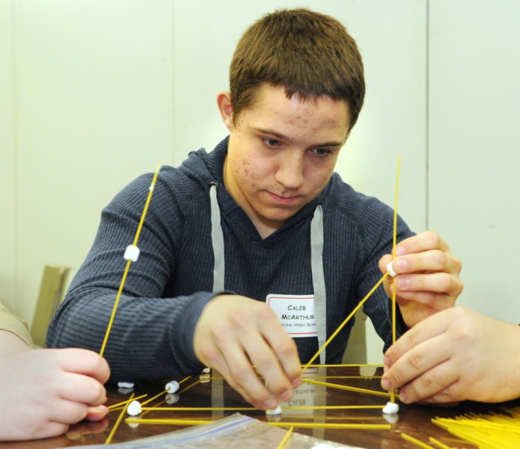 Caleb McArthur and his Richmond High School teammates build a tower from marshmallows and spaghetti during the group activity contest during the Jobs for Maine’s Graduates event on Wednesday at the Augusta Civic Center.