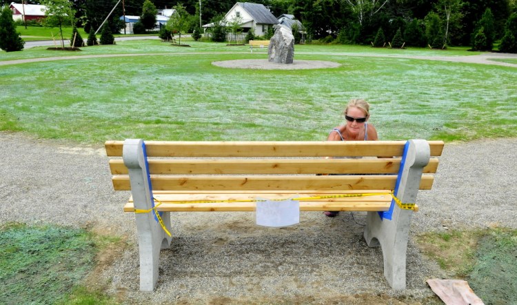 Charity Sargood paints one of the benches at Bjorn Park at the intersection on High Street and Farmington Falls Road in Farmington in August. The park will be the site of free lunches for low-income Farmington children this summer, hosted by Old South First Congregational Church.