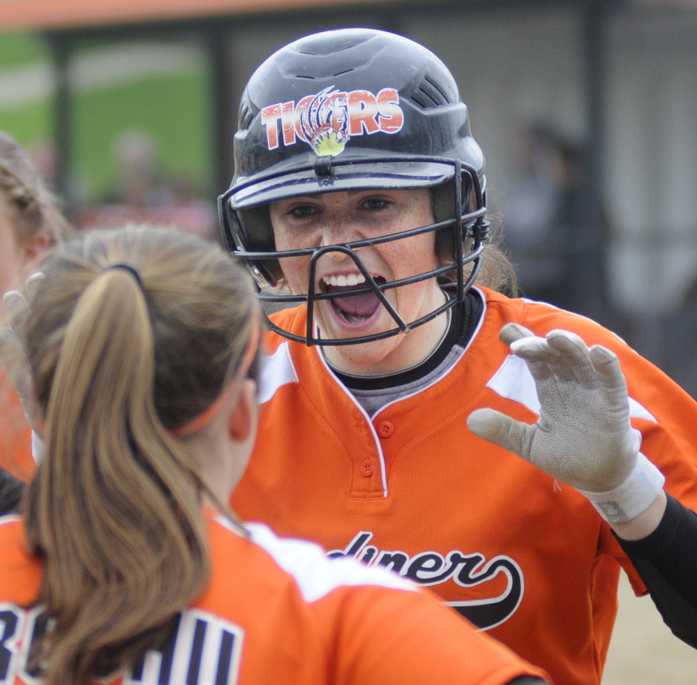 Staff photo by Andy Molloy 
 Gardiner Area High School's Lauren Chadwick is greeted at home after belting a home run during a Kennebec Valley Athletic Conference Class B game Wednesday.