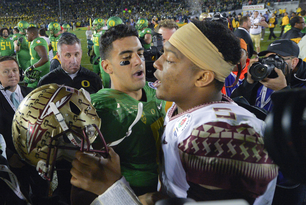 Florida State quarterback Jameis Winston, right, was selected No. 1 overall in the NFL draft to the Tampa Bay Buccaneers. The Tennessee Titans selected Oregon quarterback Marcus Mariota, left, at No. 2.