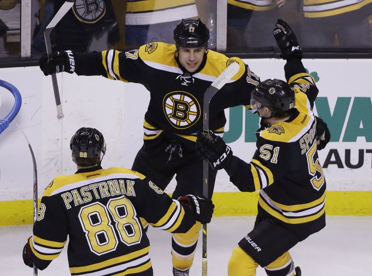 Bruins left wing Milan Lucic (17) celebrates his go-ahead goal against the Florida Panthers with teammates David Pastrnak (88) and Ryan Spooner (51) late in the third period of Tuesday night’s game in Boston. Lucic’s goal gave the Bruins a 3-2 win.