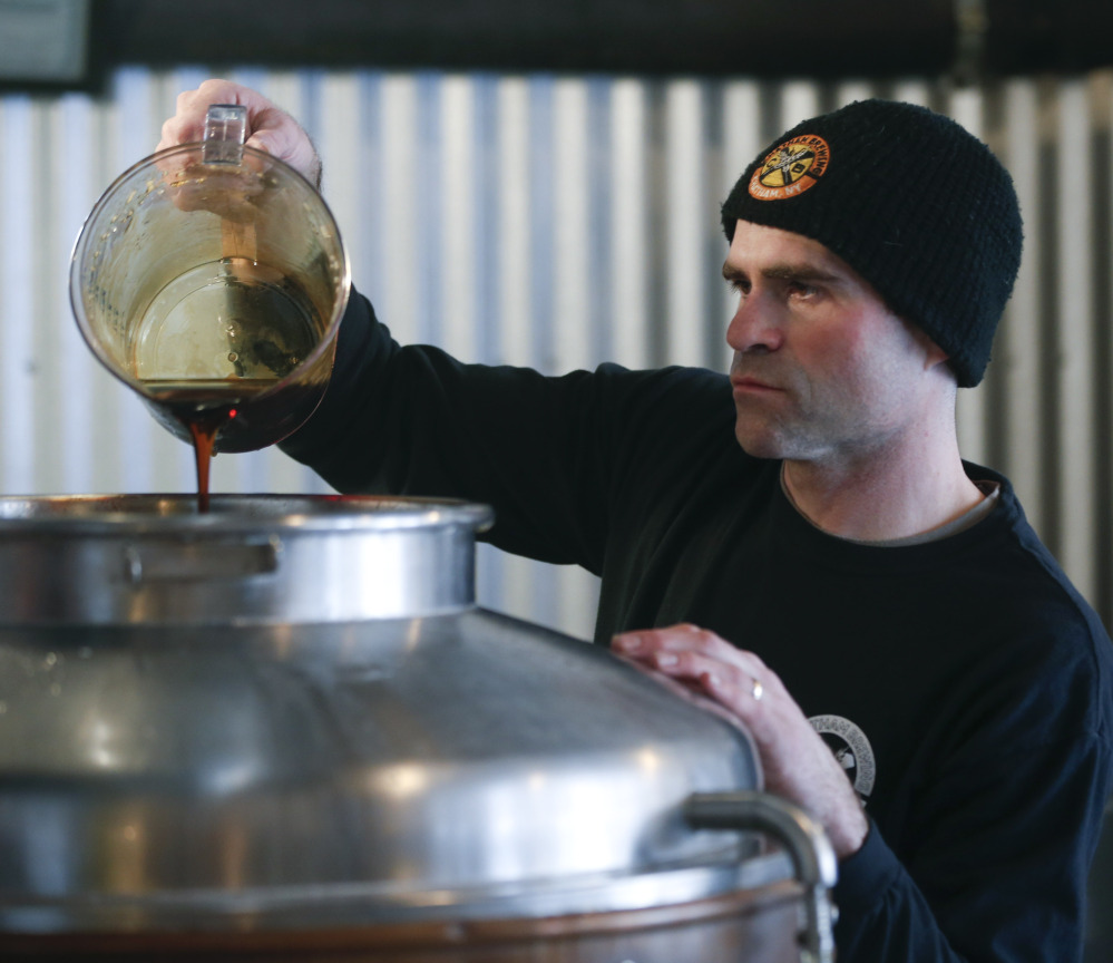 Brewer Matthew Perry adds maple syrup to beer being made at Chatham Brewing in Chatham, N.Y. Perry says the maple syrup works better with a malty beer than a hoppy one.