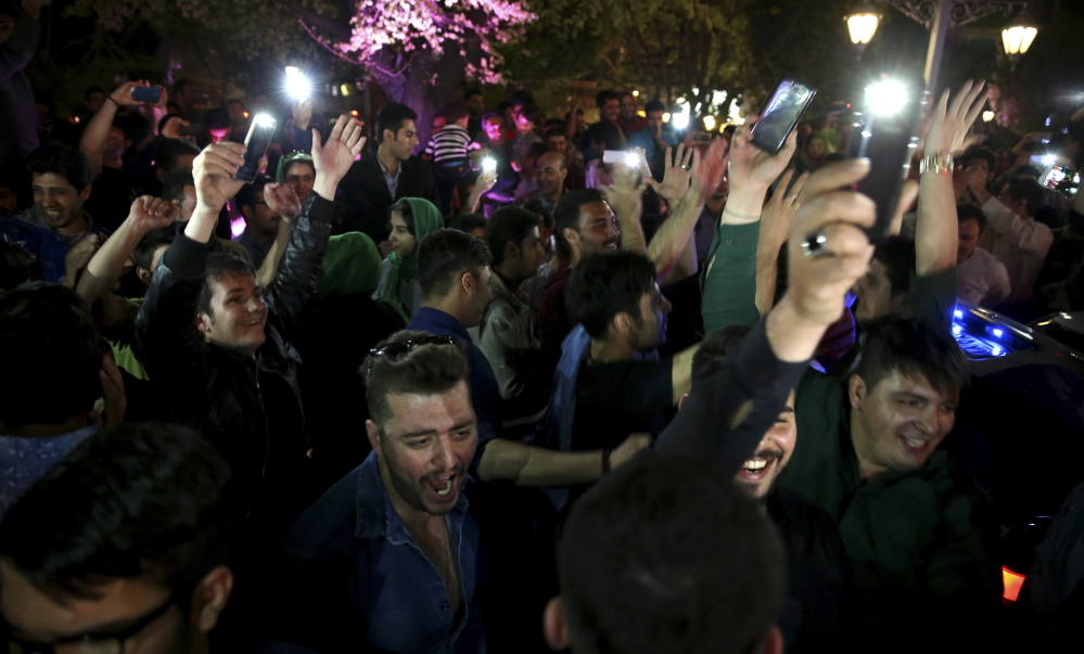 Iranians celebrate a framework agreement on Iran’s nuclear program between their country and six world powers in Tehran on Friday.